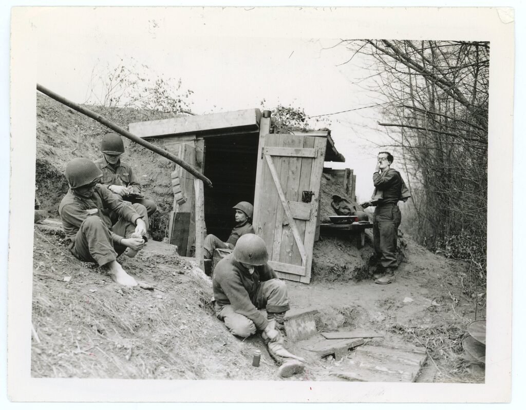 Five men of a 3rd Infantry Division squad resting at a command post near Neuf-Brisach, February 1945