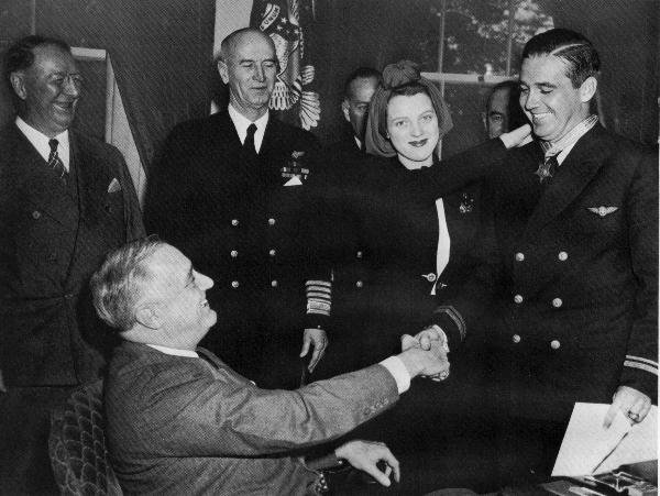 Rita O’Hare places the Medal of Honor around her husband’s neck as President Roosevelt looks on, April 1942