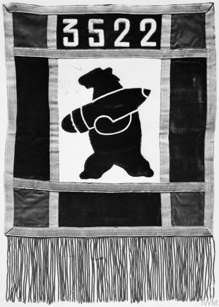 The badge of the 22nd Artillery Supply Company, showing a bear carrying a shell